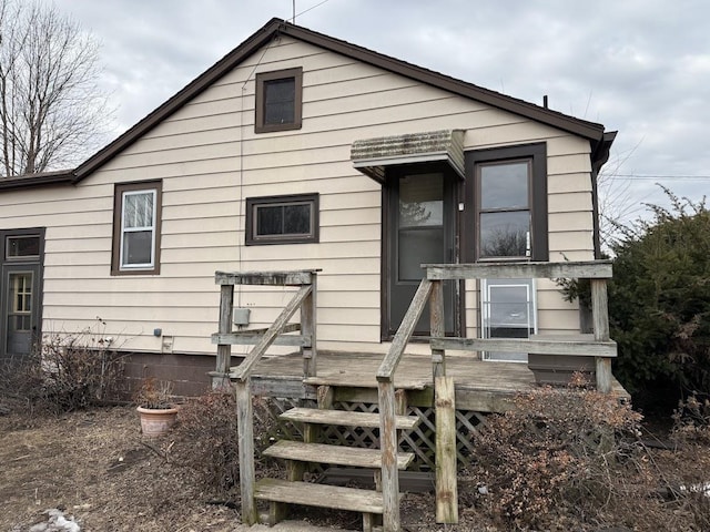 rear view of house with a wooden deck