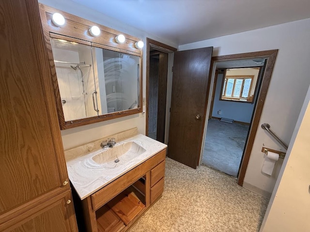 full bath featuring a shower, baseboards, and vanity