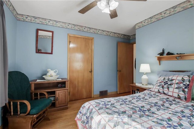 bedroom with ceiling fan and light wood finished floors