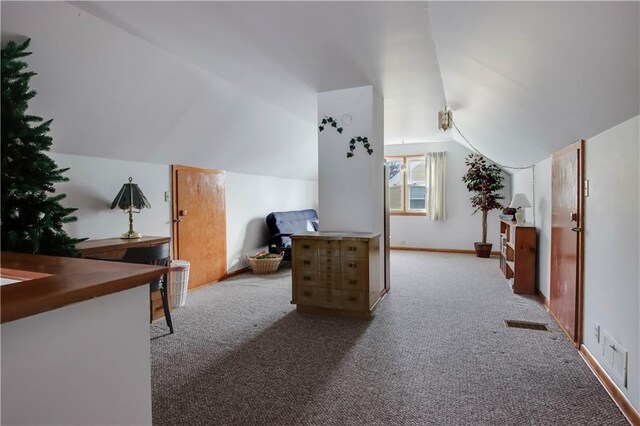 carpeted home office with visible vents, lofted ceiling, and baseboards