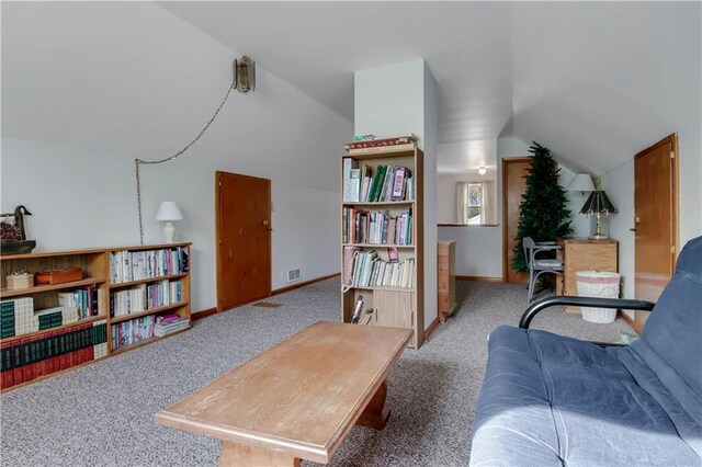 interior space featuring vaulted ceiling, carpet flooring, baseboards, and visible vents