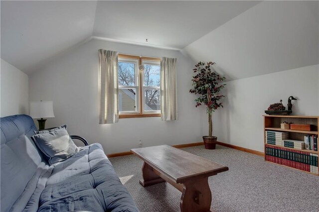 living room with baseboards, carpet, and lofted ceiling