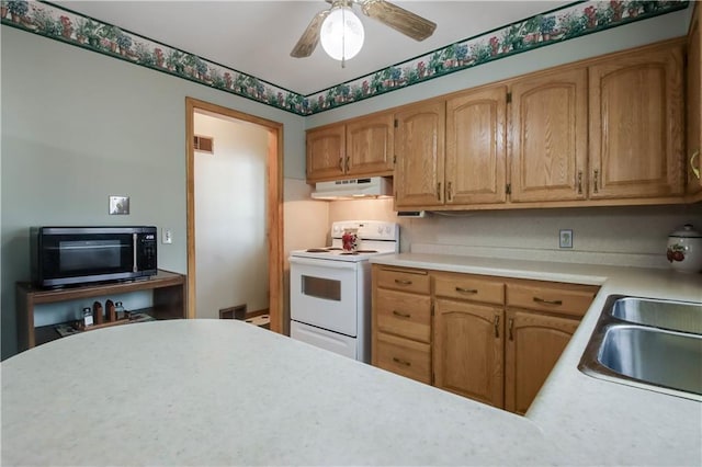 kitchen featuring a ceiling fan, under cabinet range hood, a sink, white range with electric stovetop, and light countertops