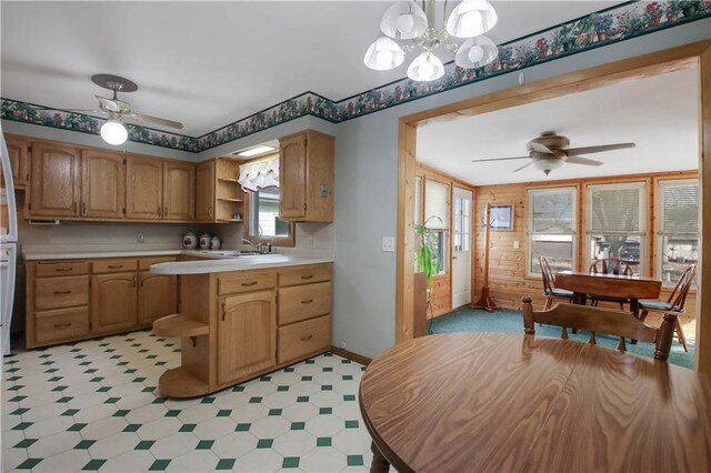 kitchen featuring a ceiling fan, light floors, open shelves, a sink, and light countertops