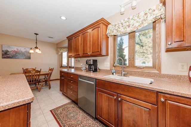 kitchen with dishwasher, light countertops, light tile patterned floors, brown cabinetry, and a sink