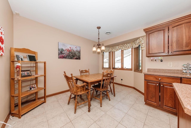 dining space with visible vents, baseboards, and a chandelier