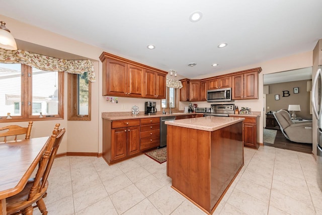 kitchen featuring baseboards, a kitchen island, recessed lighting, appliances with stainless steel finishes, and brown cabinets