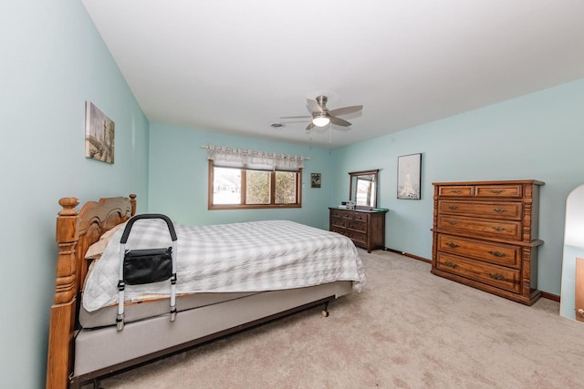 carpeted bedroom featuring a ceiling fan and baseboards