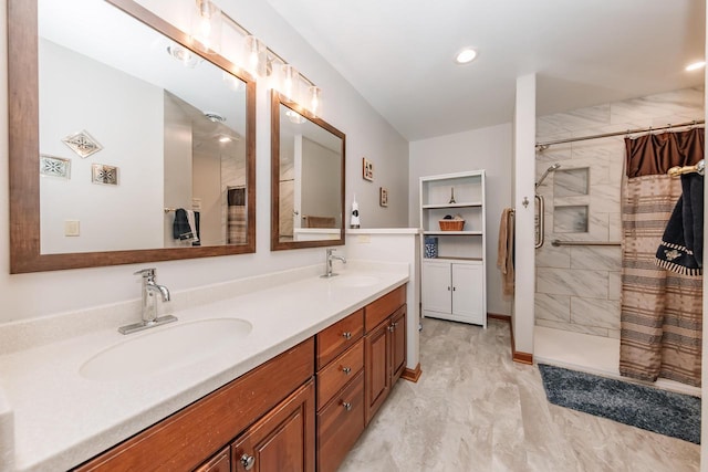 full bath featuring a sink, marble finish floor, double vanity, and a tile shower