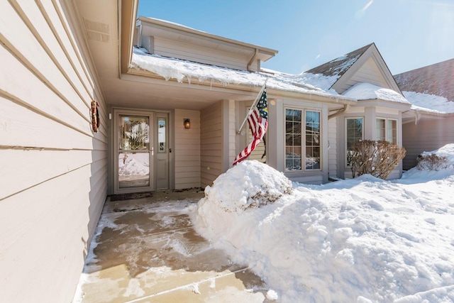 view of snow covered property entrance