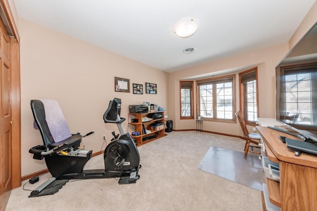 workout room with carpet flooring, visible vents, and baseboards