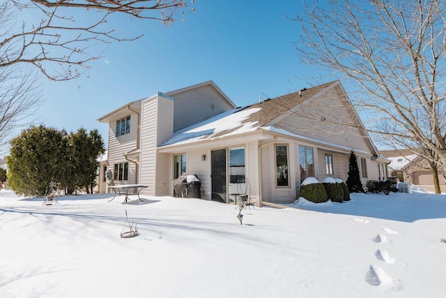 view of snow covered rear of property