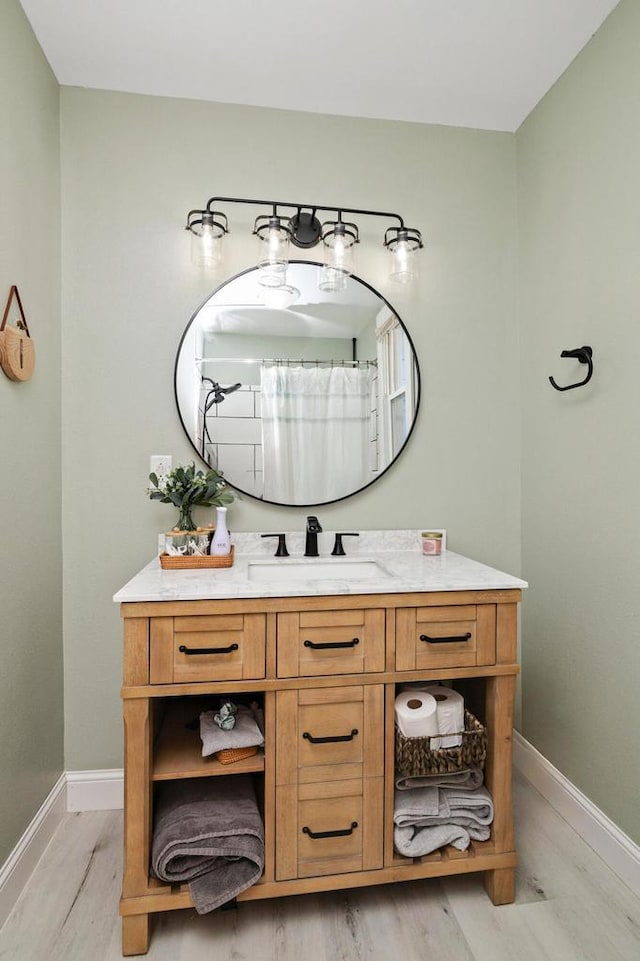 full bath with vanity and baseboards