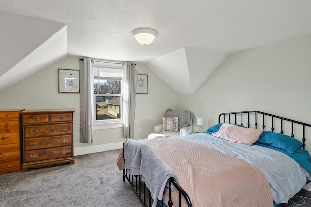 bedroom with baseboards, lofted ceiling, and carpet floors