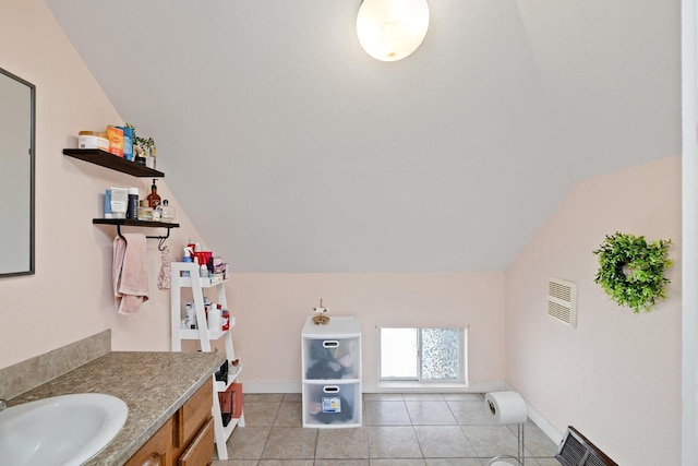 bathroom with tile patterned floors, visible vents, lofted ceiling, and vanity