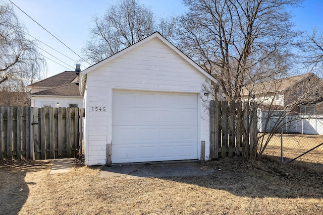 detached garage featuring fence