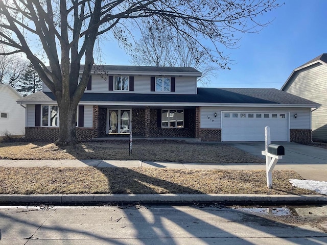 traditional home with brick siding, driveway, and an attached garage