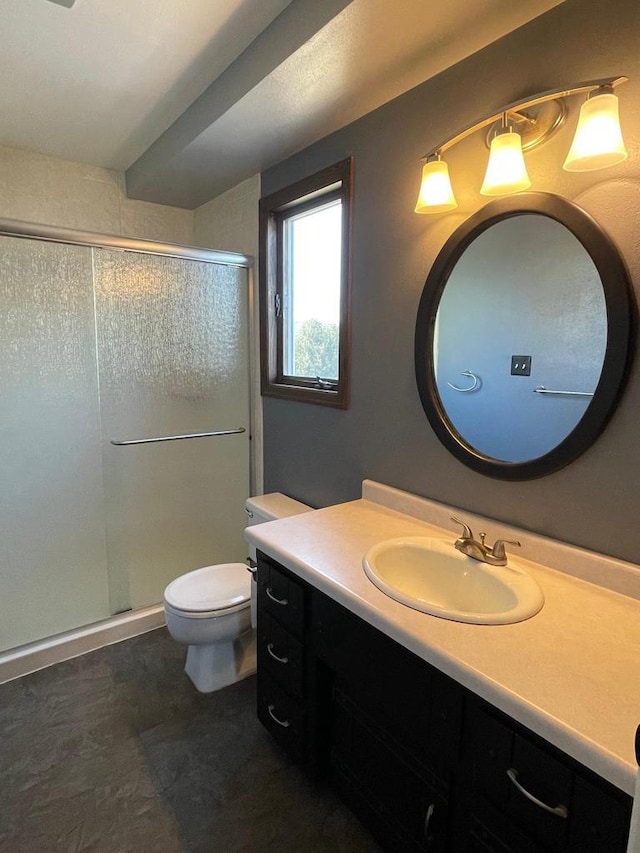 full bathroom with vanity, a shower stall, and toilet