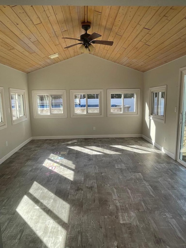 unfurnished room featuring baseboards, plenty of natural light, wood ceiling, and vaulted ceiling