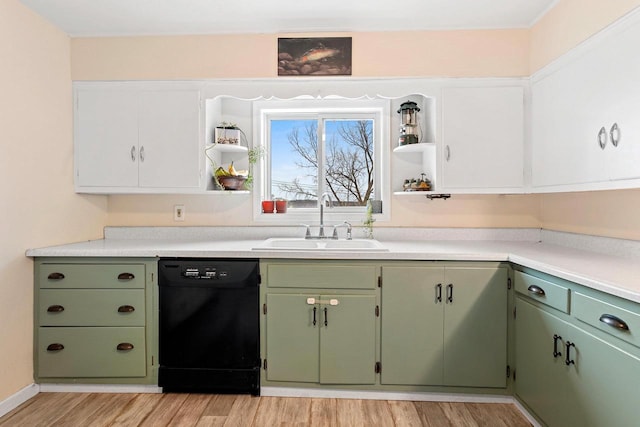 kitchen with light wood finished floors, green cabinetry, open shelves, a sink, and black dishwasher