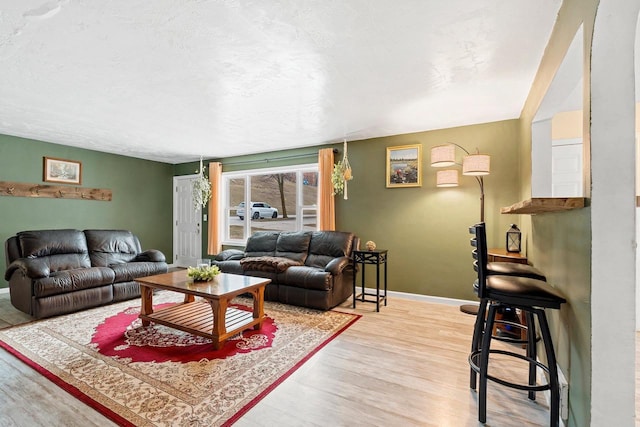 living room featuring baseboards and light wood finished floors