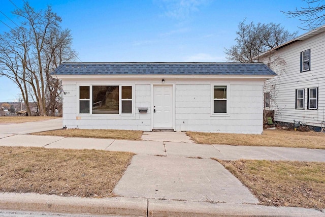 view of front of property featuring roof with shingles