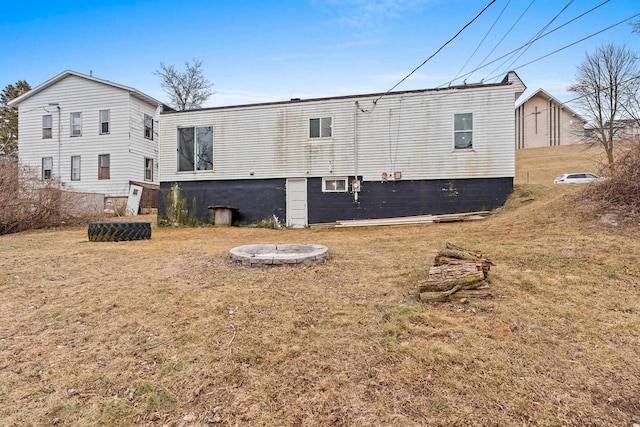 rear view of property featuring a yard