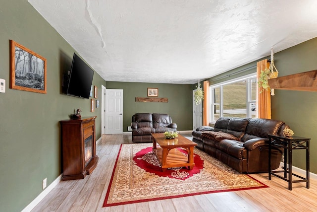 living room with wood finished floors and baseboards