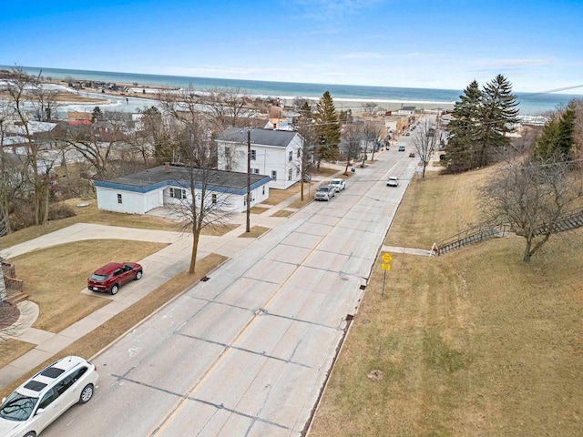 birds eye view of property featuring a view of the beach and a water view