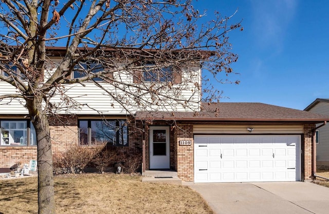 view of front of home with brick siding, driveway, a front lawn, and a garage