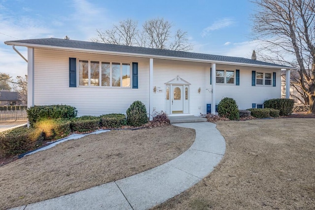 split foyer home featuring fence