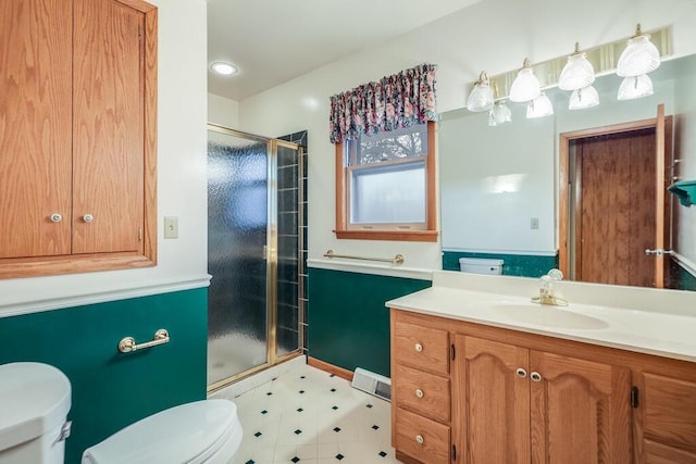 full bath with vanity, toilet, and a shower stall