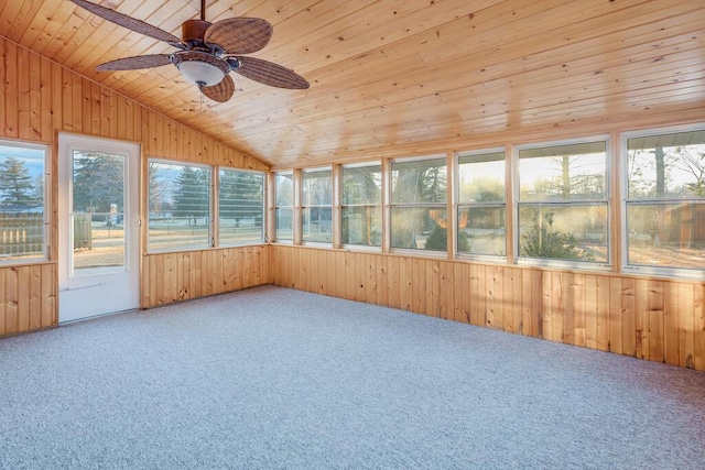 unfurnished sunroom featuring a ceiling fan, vaulted ceiling, wooden ceiling, and a wealth of natural light