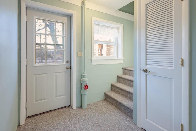 doorway to outside featuring stairway, plenty of natural light, and light carpet