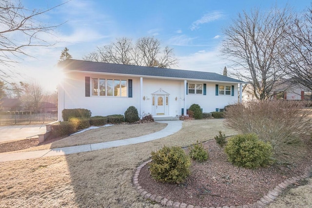 bi-level home featuring fence