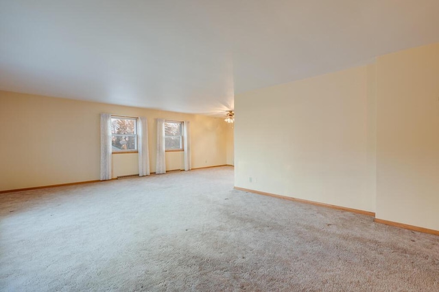 spare room with carpet and baseboards