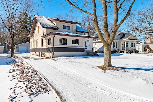 view of front of property with an outbuilding and a detached garage