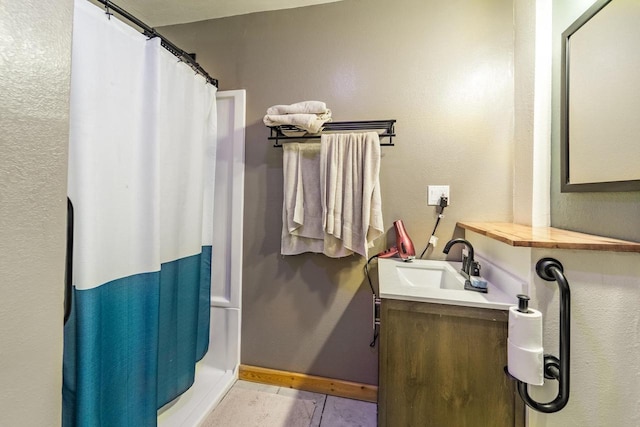 bathroom with baseboards, a shower with curtain, vanity, and tile patterned flooring