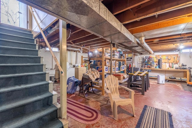 below grade area with stairs, independent washer and dryer, and a sink