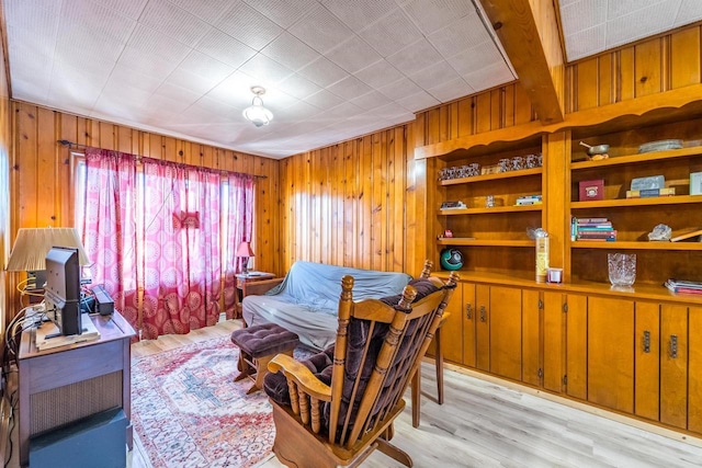 interior space with wood walls and light wood-style floors