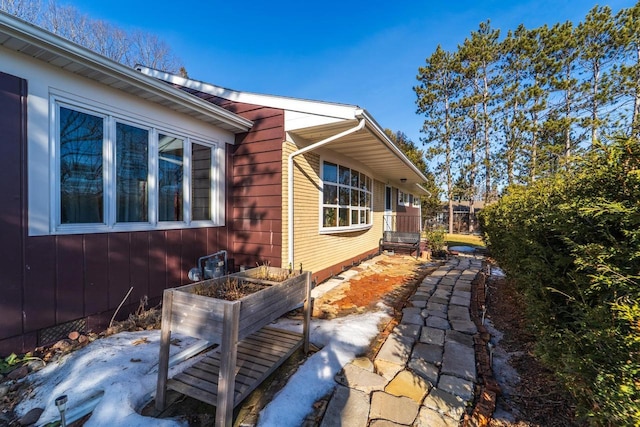 view of side of home featuring a vegetable garden