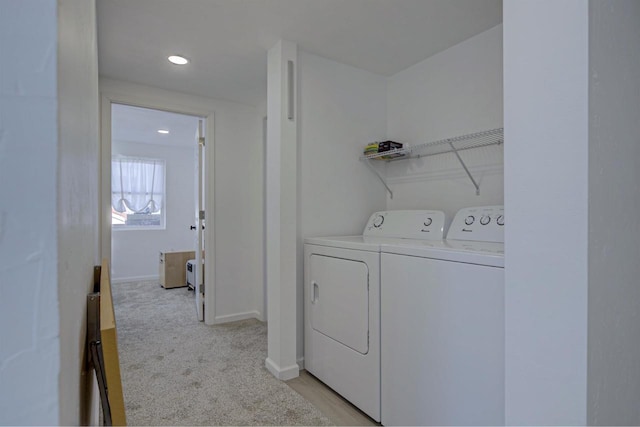 laundry room with baseboards, light colored carpet, laundry area, and washing machine and clothes dryer