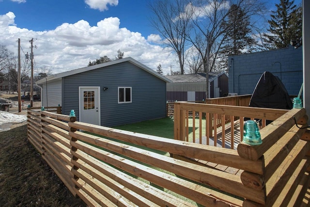 wooden deck with a lawn, an outdoor structure, and fence