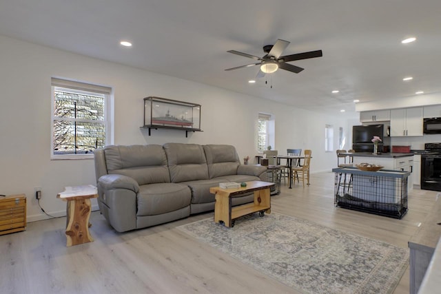 living room with light wood-style flooring, recessed lighting, baseboards, and ceiling fan