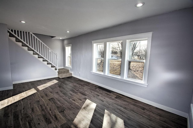 unfurnished living room with dark wood-style floors, recessed lighting, stairs, and baseboards