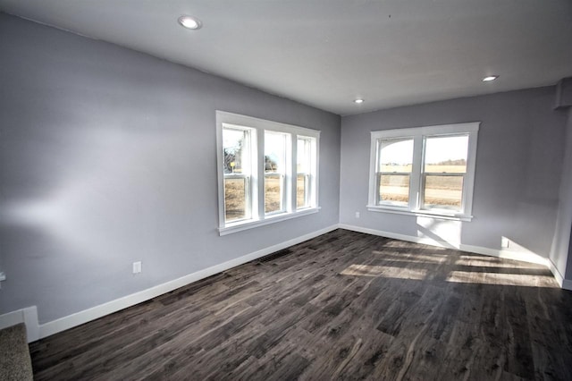 unfurnished room featuring recessed lighting, baseboards, and dark wood-style flooring