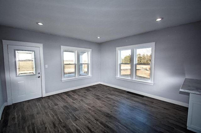 foyer entrance with dark wood finished floors, visible vents, recessed lighting, and baseboards