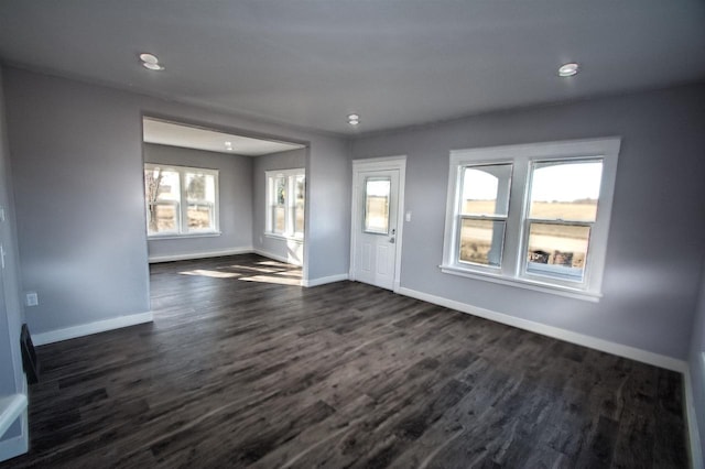 foyer with baseboards and dark wood-style floors