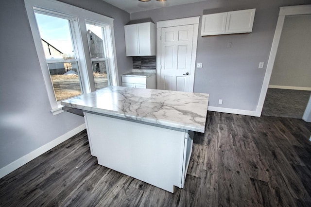 kitchen featuring baseboards, dark wood-style floors, and white cabinetry