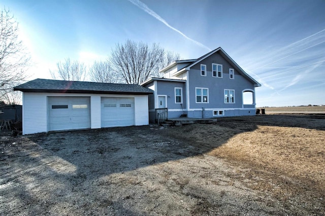 rear view of house with an outbuilding and a detached garage